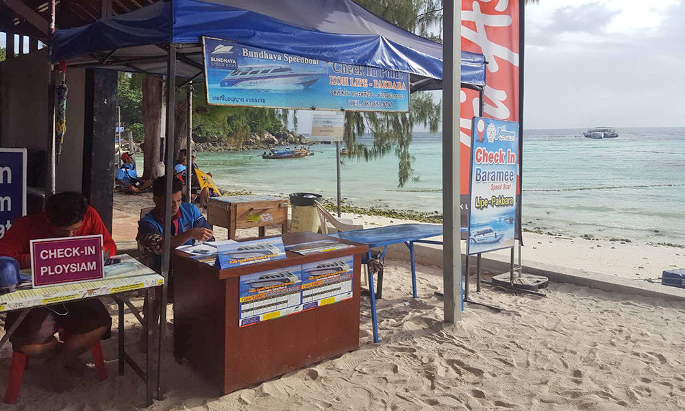 Ploysiam check-in counter on Koh Lipe beach for speedboat departure to Pak Bara Pier