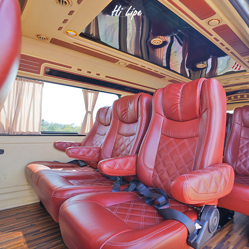 Comfortable red leather seats inside shared van for Hat Yai to Koh Lipe transfer