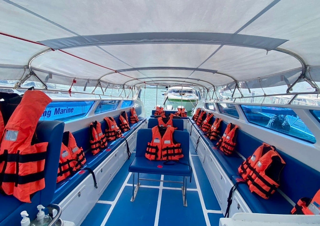Covered speedboat passenger seating with blue seats and orange life jackets