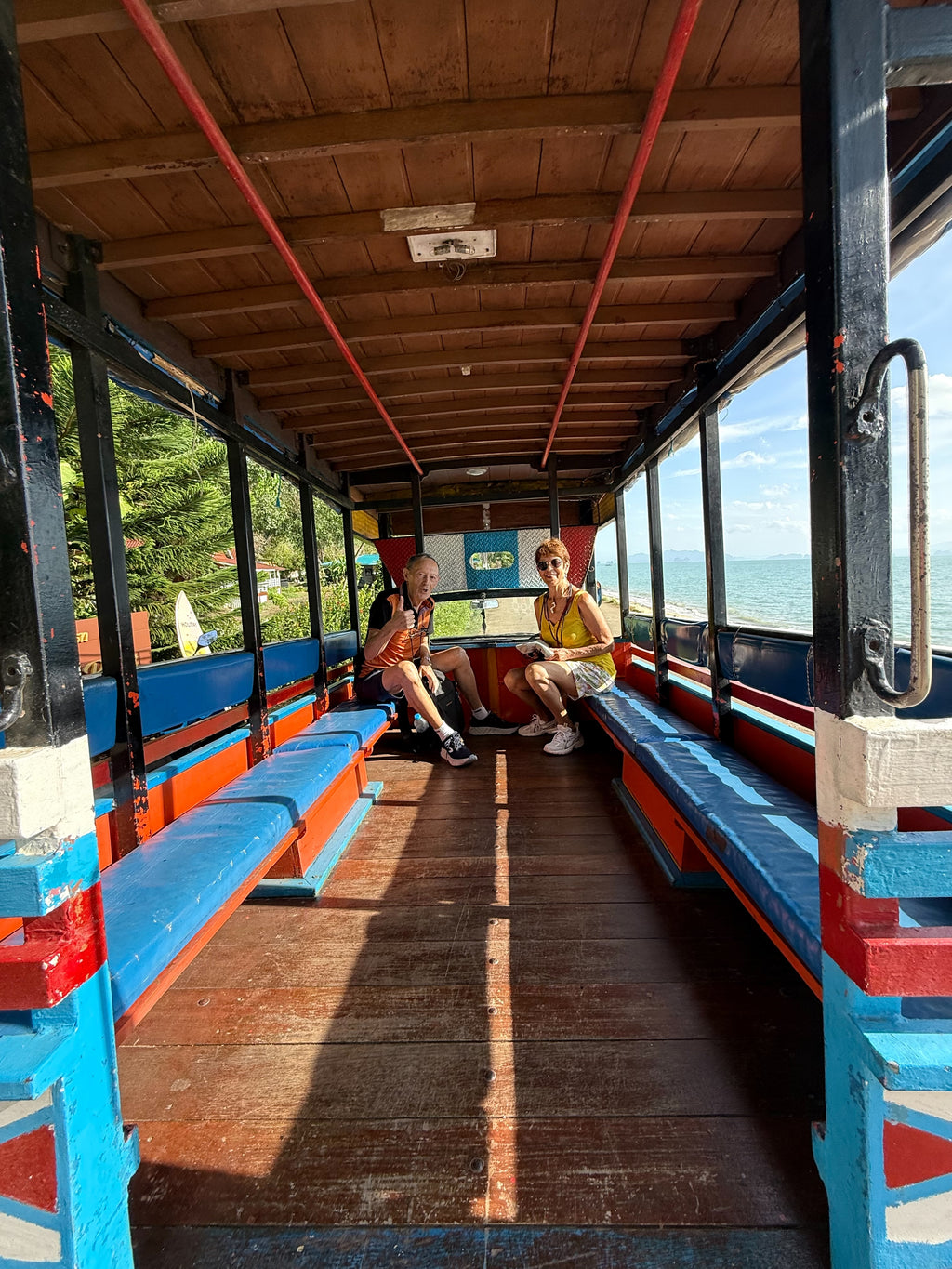 Colourful shared transfer boat at Manoh Pier, Koh Yao Noi with passengers