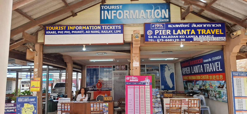 Lanta Tourist Information counter at Saladan Pier with ticket desks and Pier Lanta Travel signs