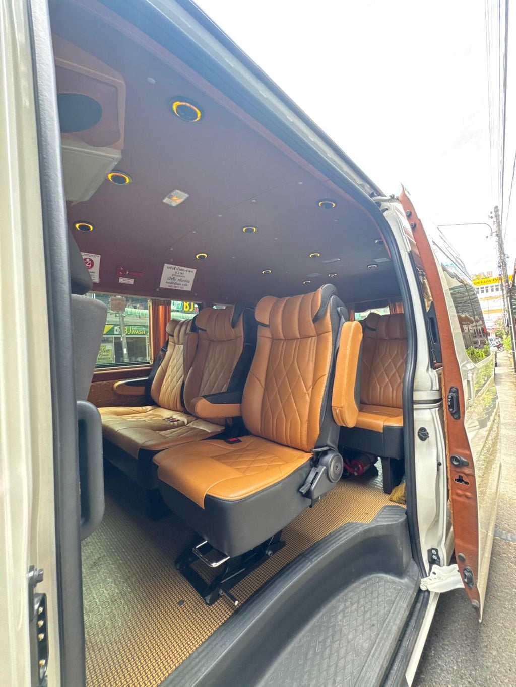 Spacious interior of private transfer van with premium leather seats for Ao Nang to Phuket Airport transfer